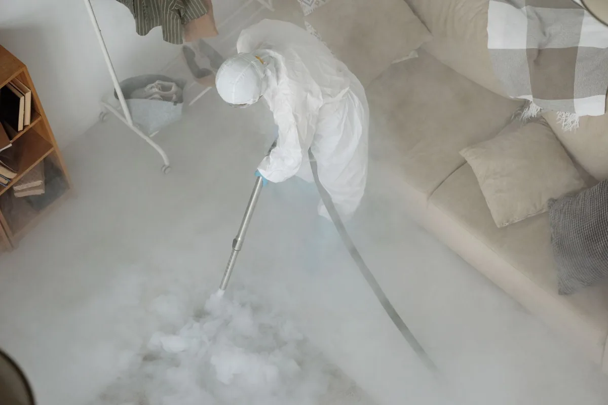 Biohazard cleanup technician in protective equipment, Louisville, CO